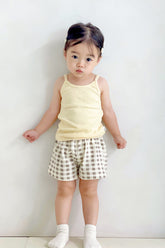 Toddler in Avauma butter check tank top set – light yellow sleeveless top with beige gingham shorts